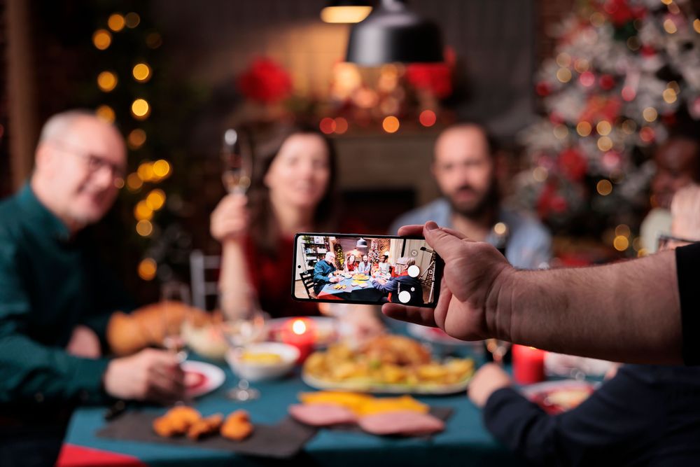 family-christmas-celebration-photo-smartphone-screen-selective-focus-people-looking-mobile-phone-camera-blurred-background-xmas-holidays-friends-gathering-together.jpg